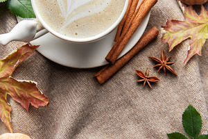 Autumn coffee latte with heart art and warm spices