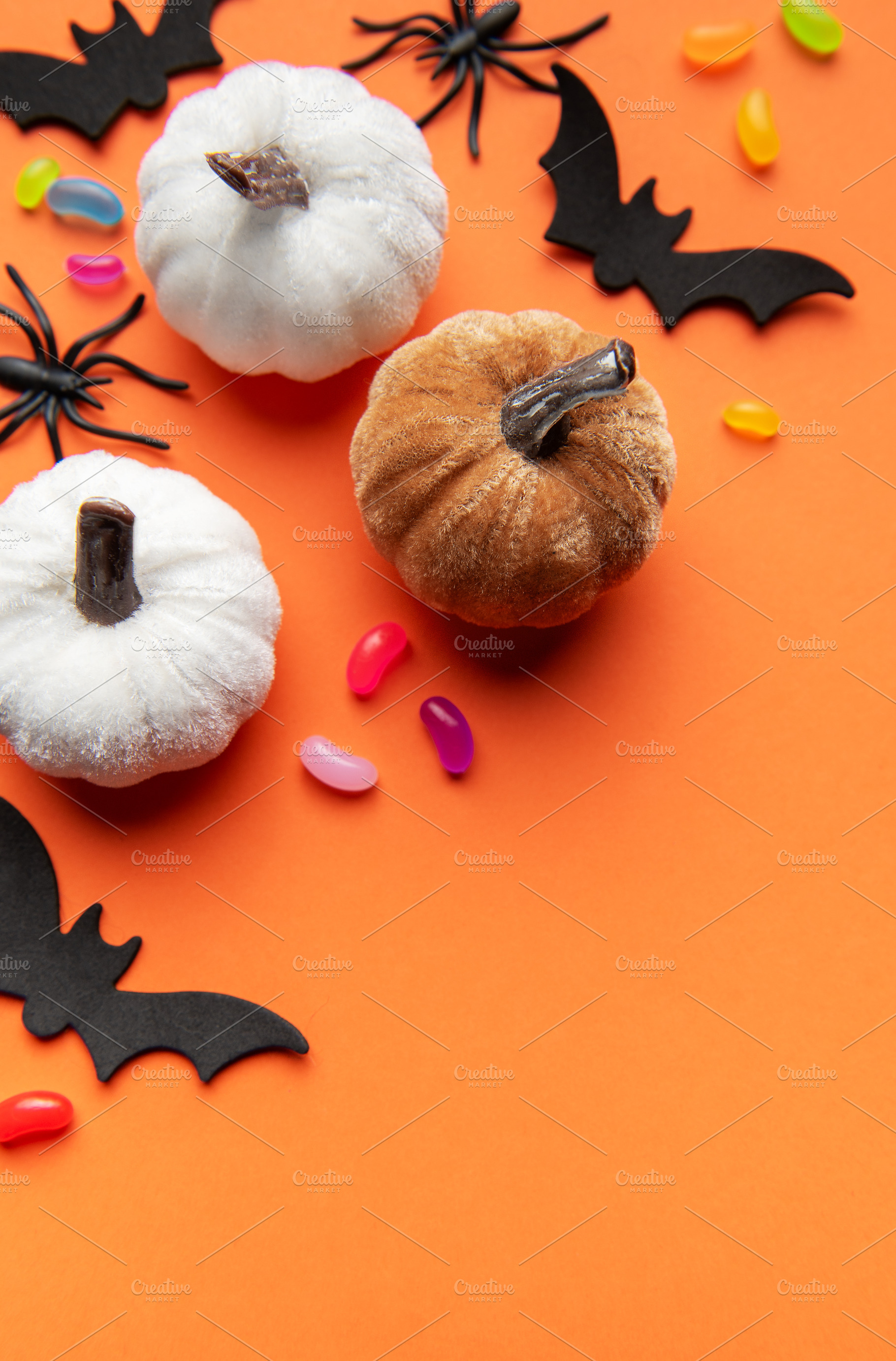 Halloween pumpkins bats spiders and candy corn on orange backgro, a Holiday Photo by Olena Rudo