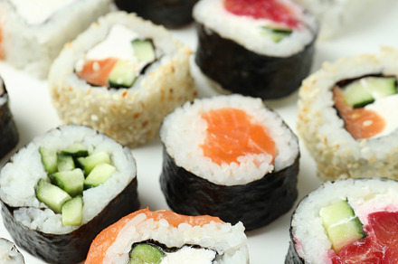 Concept of tasty food with sushi rolls on white background, a Food & Drink Photo by AtlasStudio PRO