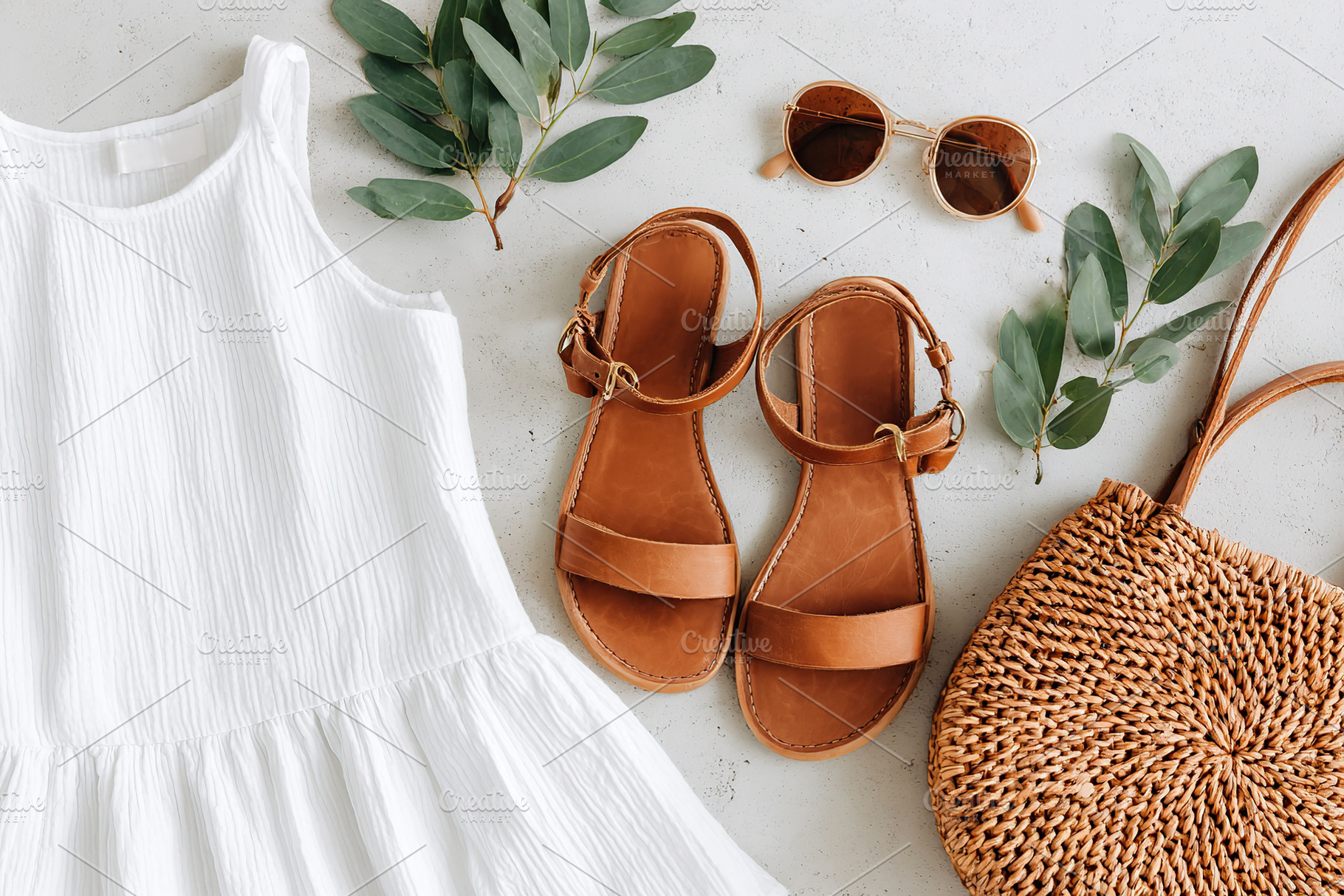 Light cotton summer outfit flat lay with accessories and greenery for a breezy, a Beauty & Fashion Photo by AlyaAnd