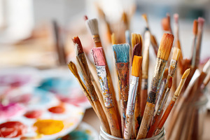 Colorful paintbrushes and palette on watercolor background, an Arts & Entertainment Photo by AlyaAnd