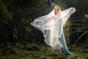 Happy woman in a blue gown, a Person Photo by Imaginarium