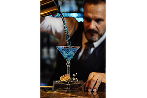Barman is making cocktail at night