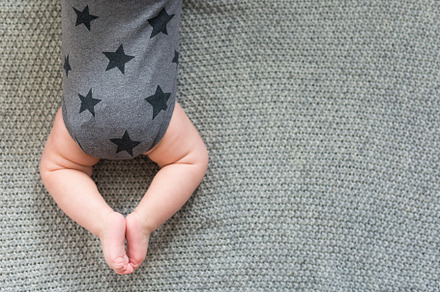 Cute little baby lying on knitted