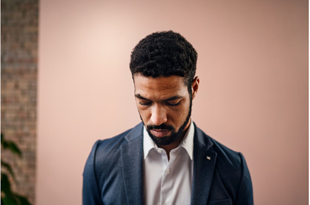 Serious young businessman looking, a Person Photo by HalfPoint
