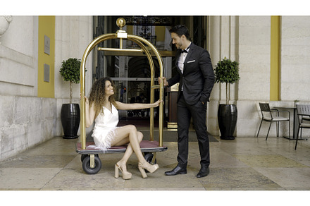 Elegant couple at entrance to hotel, a Person Photo by Media Whale Stock