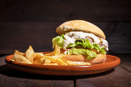 Delicious gourmet beef burger with creamy sauce, lettuce, tomato and guacamole,, a Food & Drink Photo by david.herraez.calzad