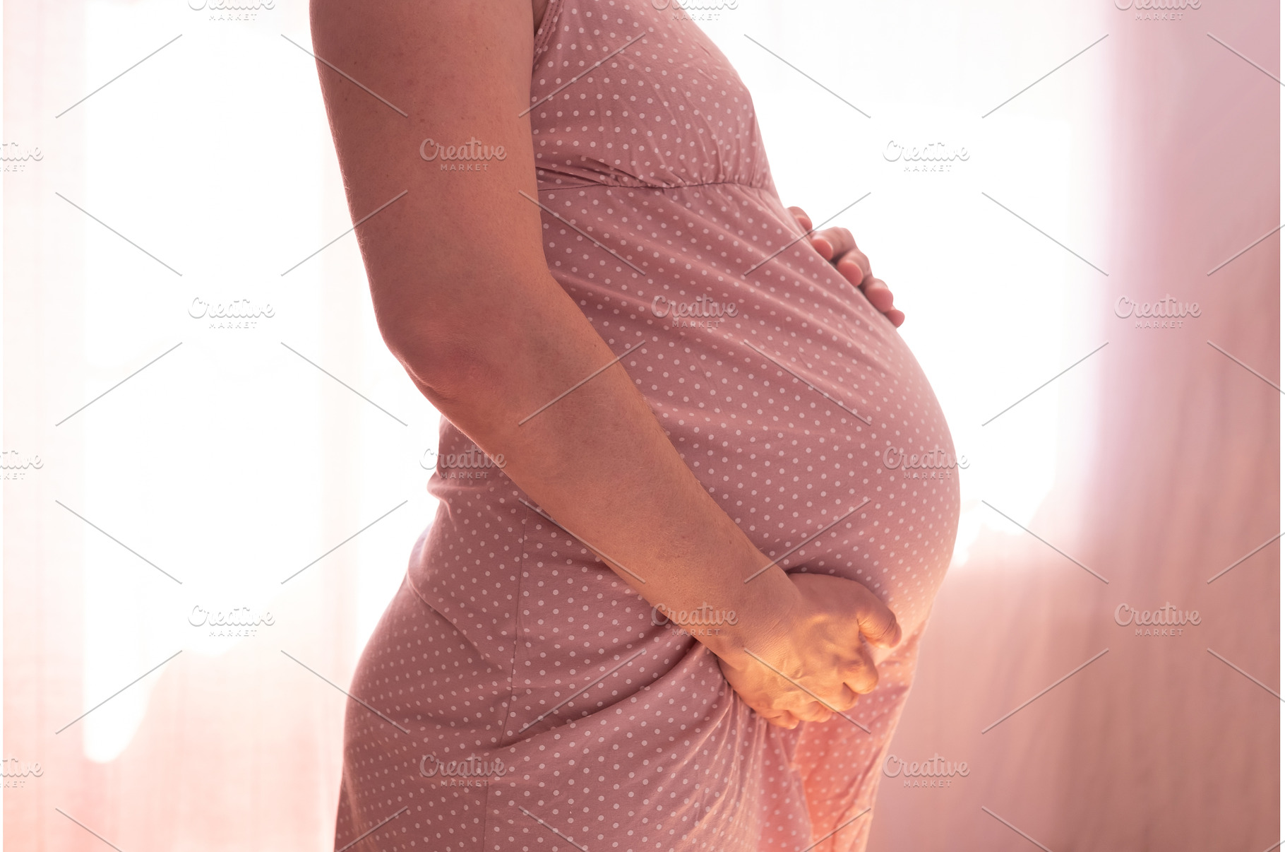 Pregnant woman touching belly, a Person Photo by Koldunova