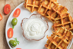 Top view of Homemade Potato Waffles, ricotta cheese and mayonese sauce. Served, a Food & Drink Photo by Budarinphoto