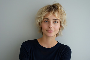 A young Caucasian woman with short, tousled blonde hair poses confidently again, a Person Photo by ImageMir