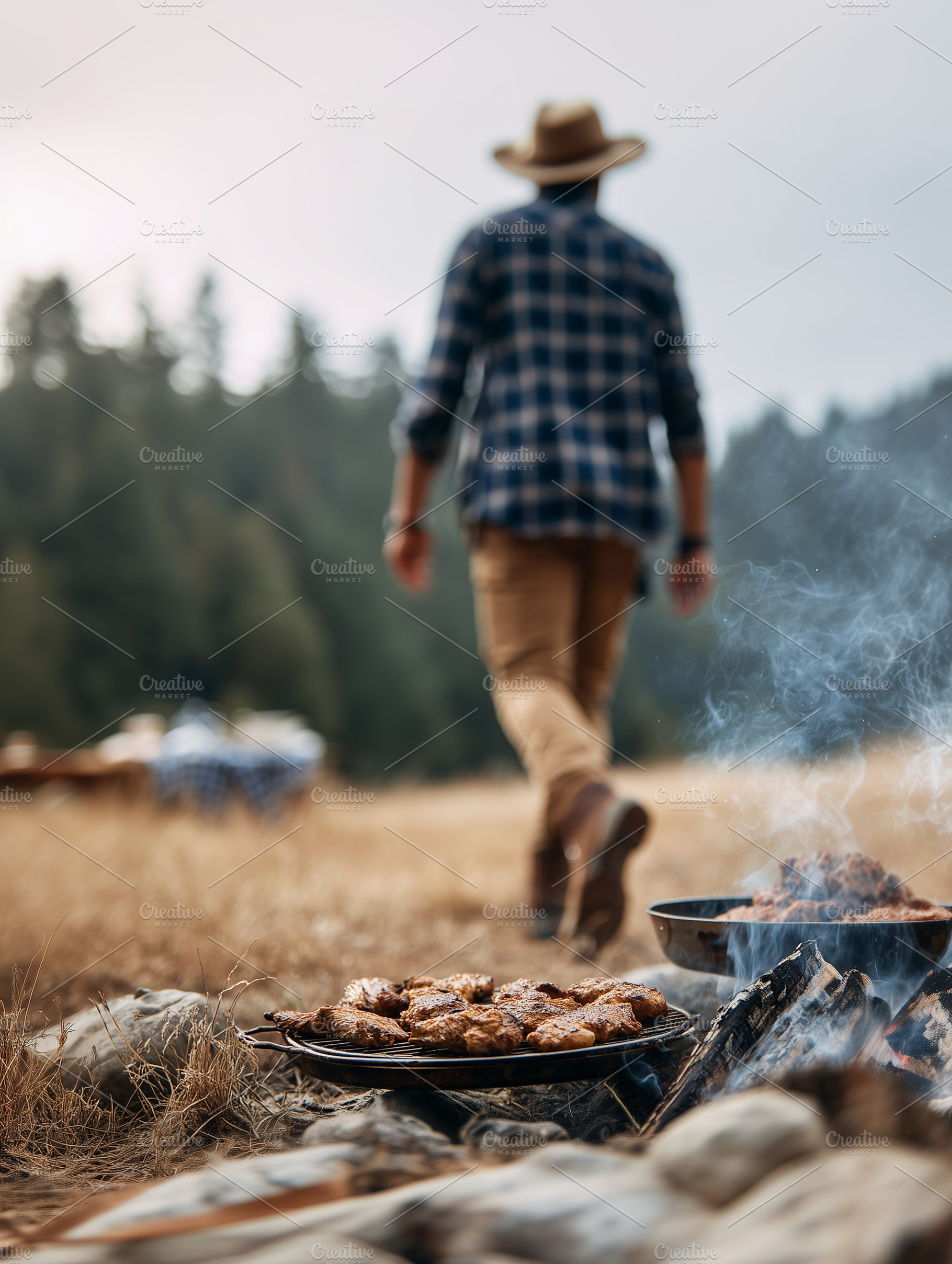 Man grilling meat over campfire in, a Person Photo by MistyDay