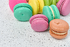 Assortment of colorful macarons in pink, green, yellow, and oran, a Food & Drink Photo by ndanko
