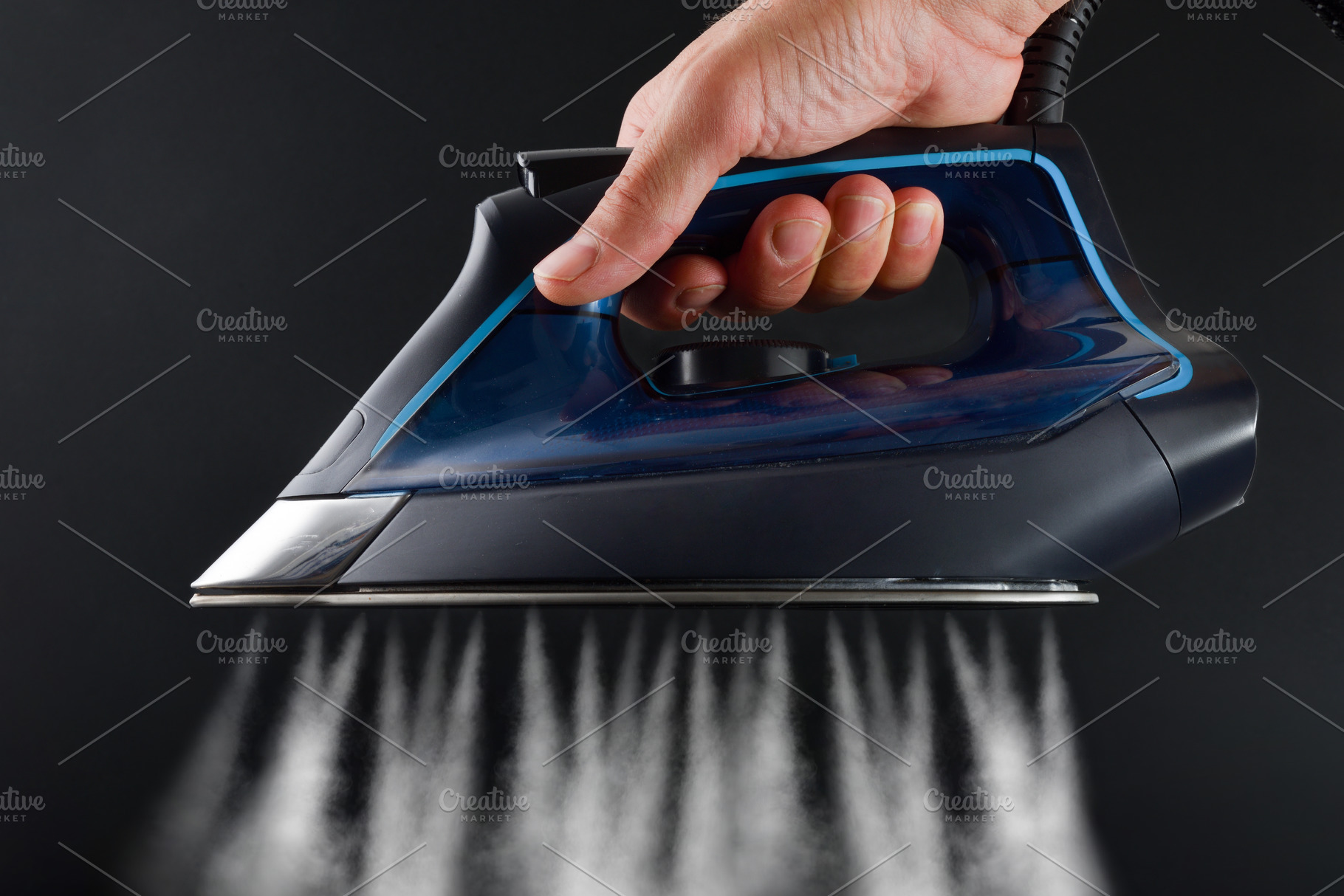 Hand operating steam iron and jets coming out dark background, a Sports & Recreation Photo by Davizro's Market