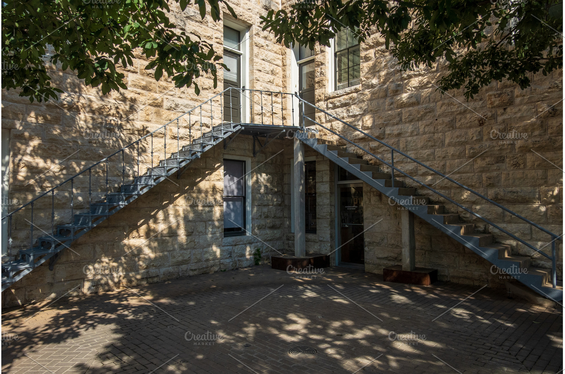 Dual metal staircases in courtyard, an Architecture Photo by Backyard Stock