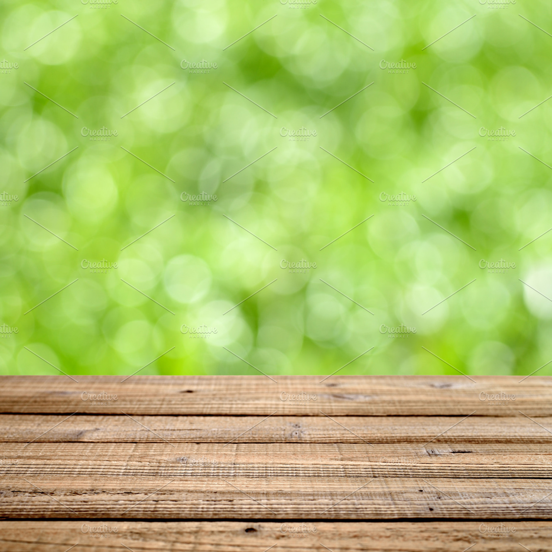 Wooden table with green bokeh