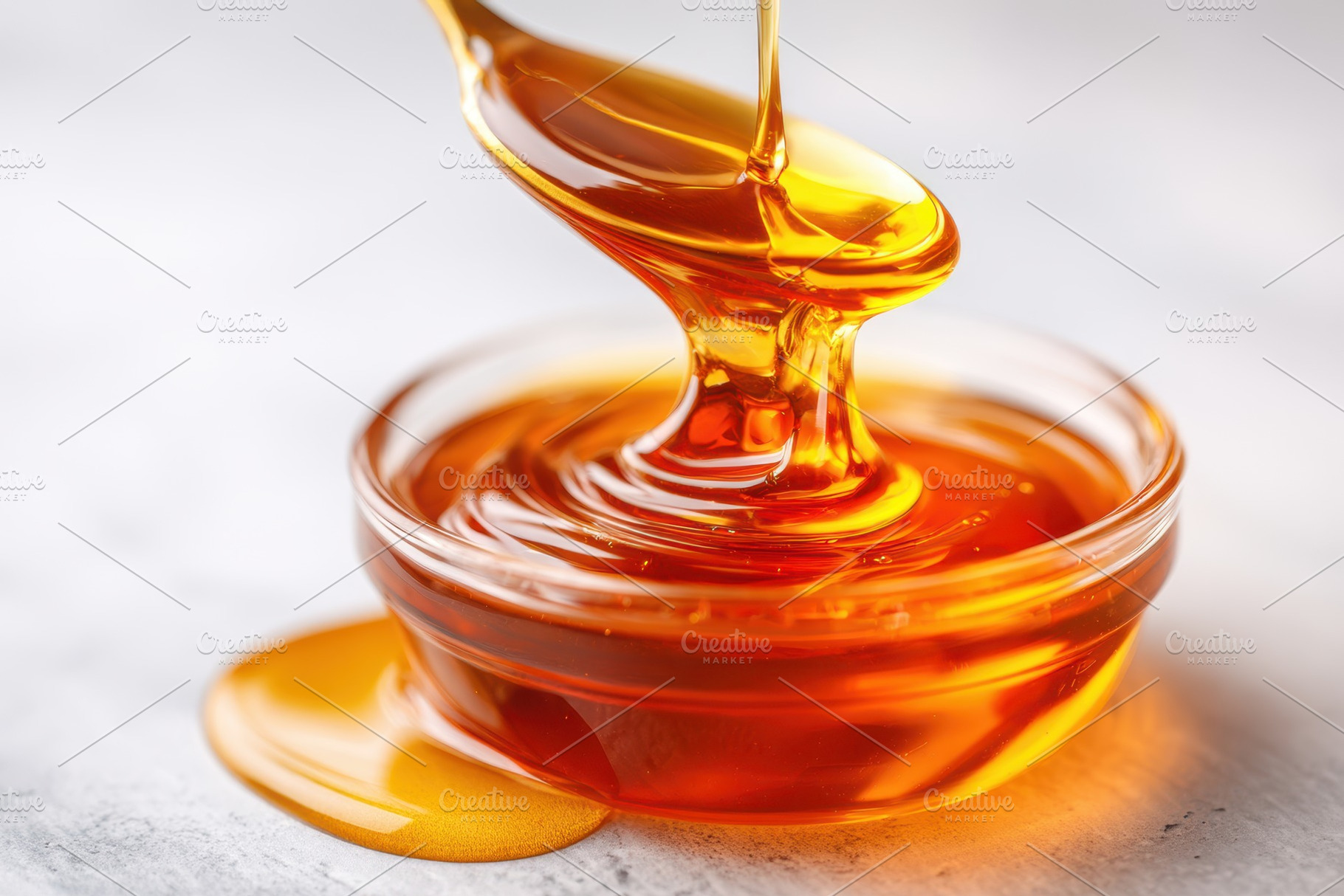 Golden honey pouring into glass bowl, a Food & Drink Photo by AlyaAnd