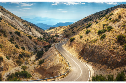 Aerial view of winding mountain road, a Transportation Photo by den-belitsky