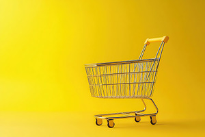 Empty shopping cart on yellow background, a Food & Drink Photo by AlyaAnd