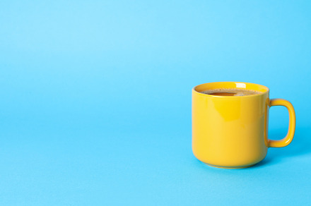 Cup of coffee on blue background, space for text, a Food & Drink Photo by AtlasStudio PRO