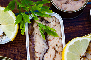 Cans of preserves. In the center a can of mackerel in oil, a Food & Drink Photo by José Manuel Gelpi