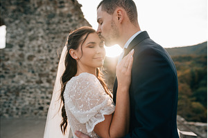 Groom kissing bride on her forehead., a Person Photo by HalfPoint