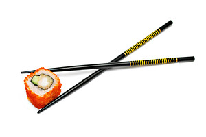 Single japan sushi roll in the chopsticks, a Photo by saiko3p