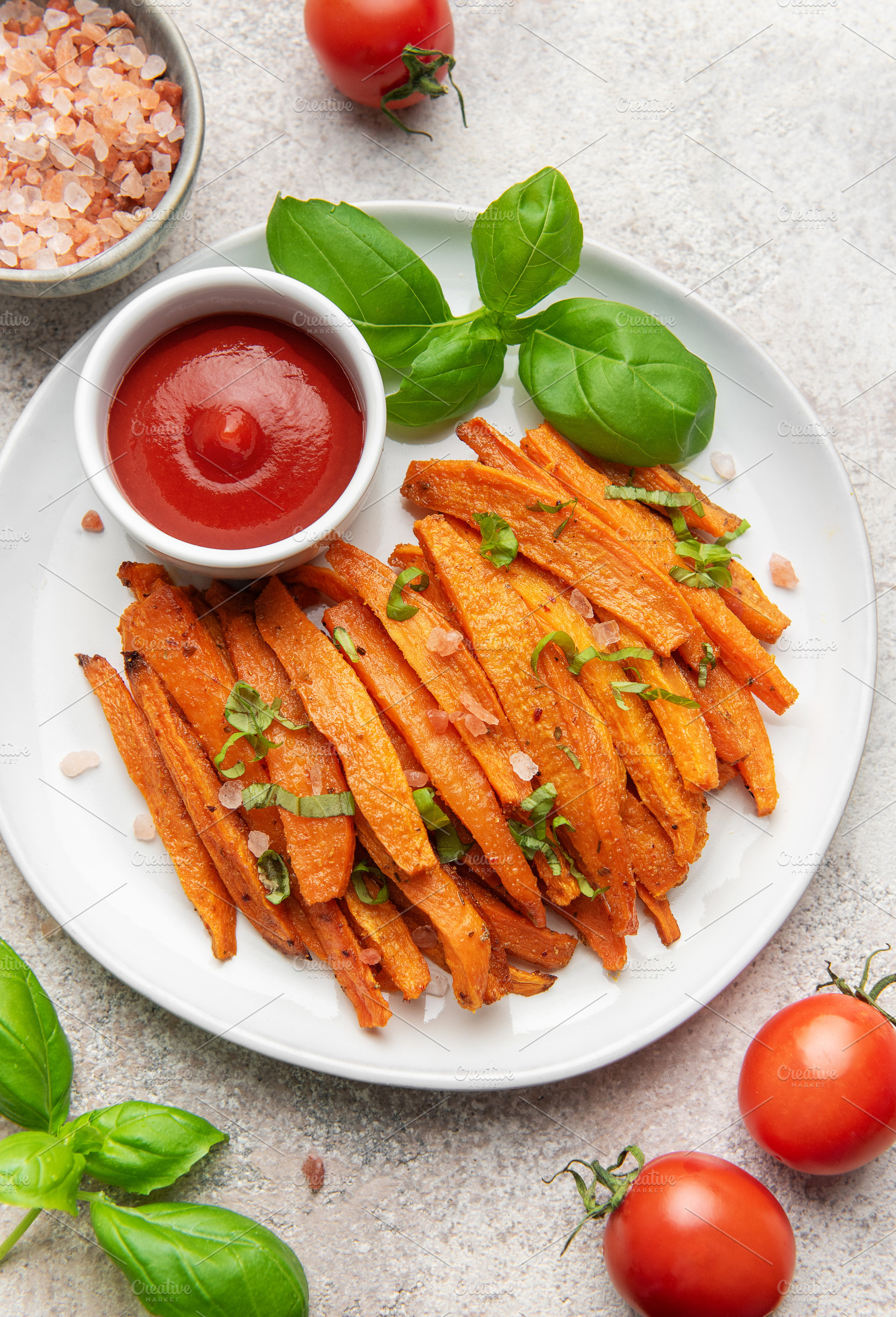 Sweet potato fries with ketchup and fresh basil, a Food & Drink Photo by Olena Rudo