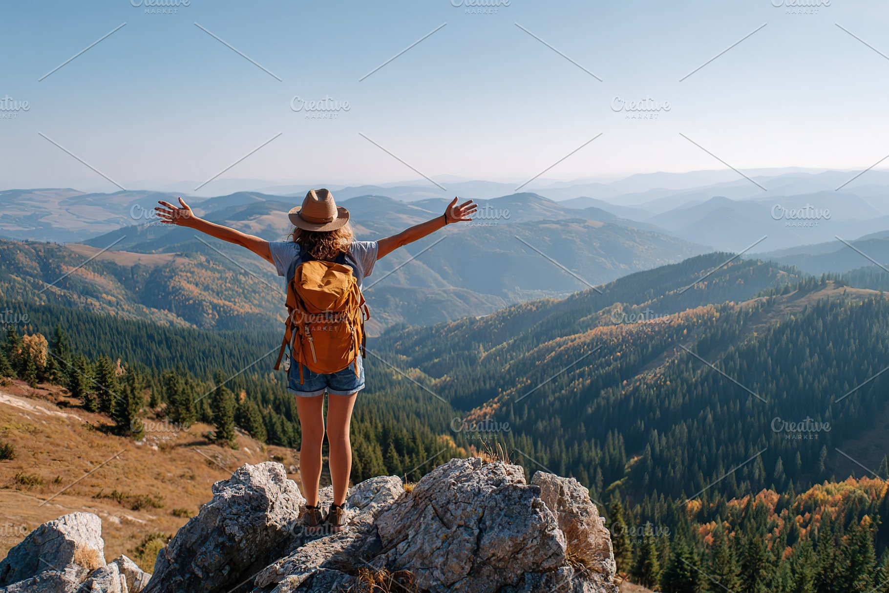 Standing on a mountaintop enjoying the vast view of rolling hills and valleys b, a Person Photo by AlyaAnd