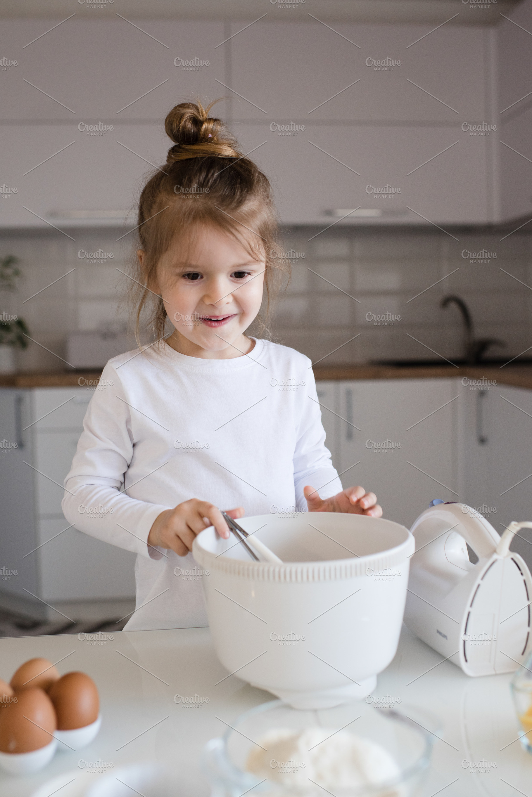 Child girl making cake, a Person Photo by morrowlight