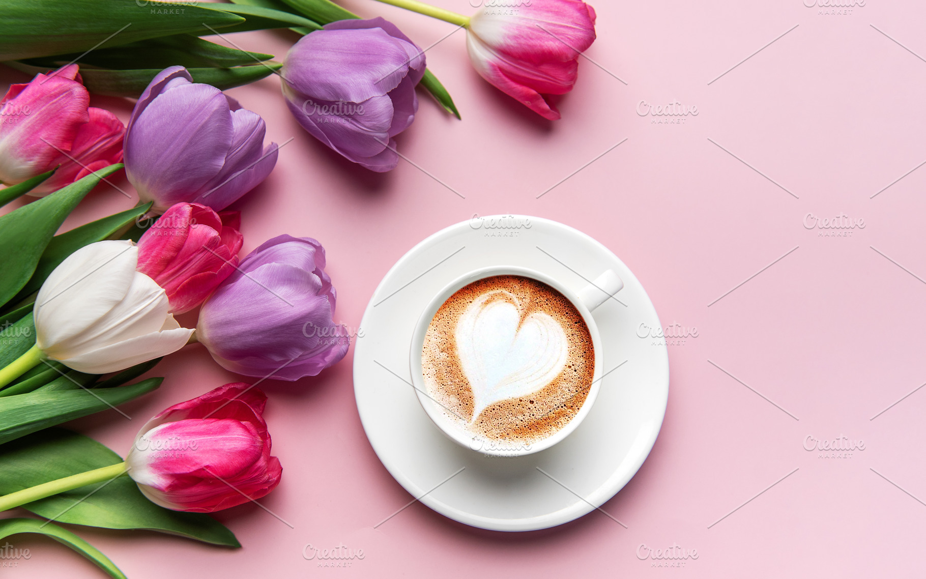 Tulips and coffee with latte art heart on pink background, a Holiday Photo by Olena Rudo