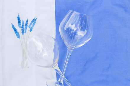 Two glasses on tablecloth with embroidery, a Food & Drink Photo by Artsaba Family