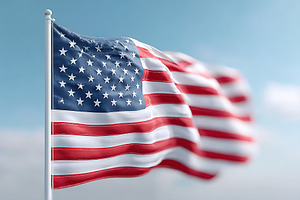 Beautiful American flag waving in the breeze against a clear blue sky, an Abstract Photo by AlyaAnd