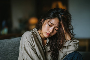 Sad woman sitting alone feeling depr, a Photo by Pixeness Studio