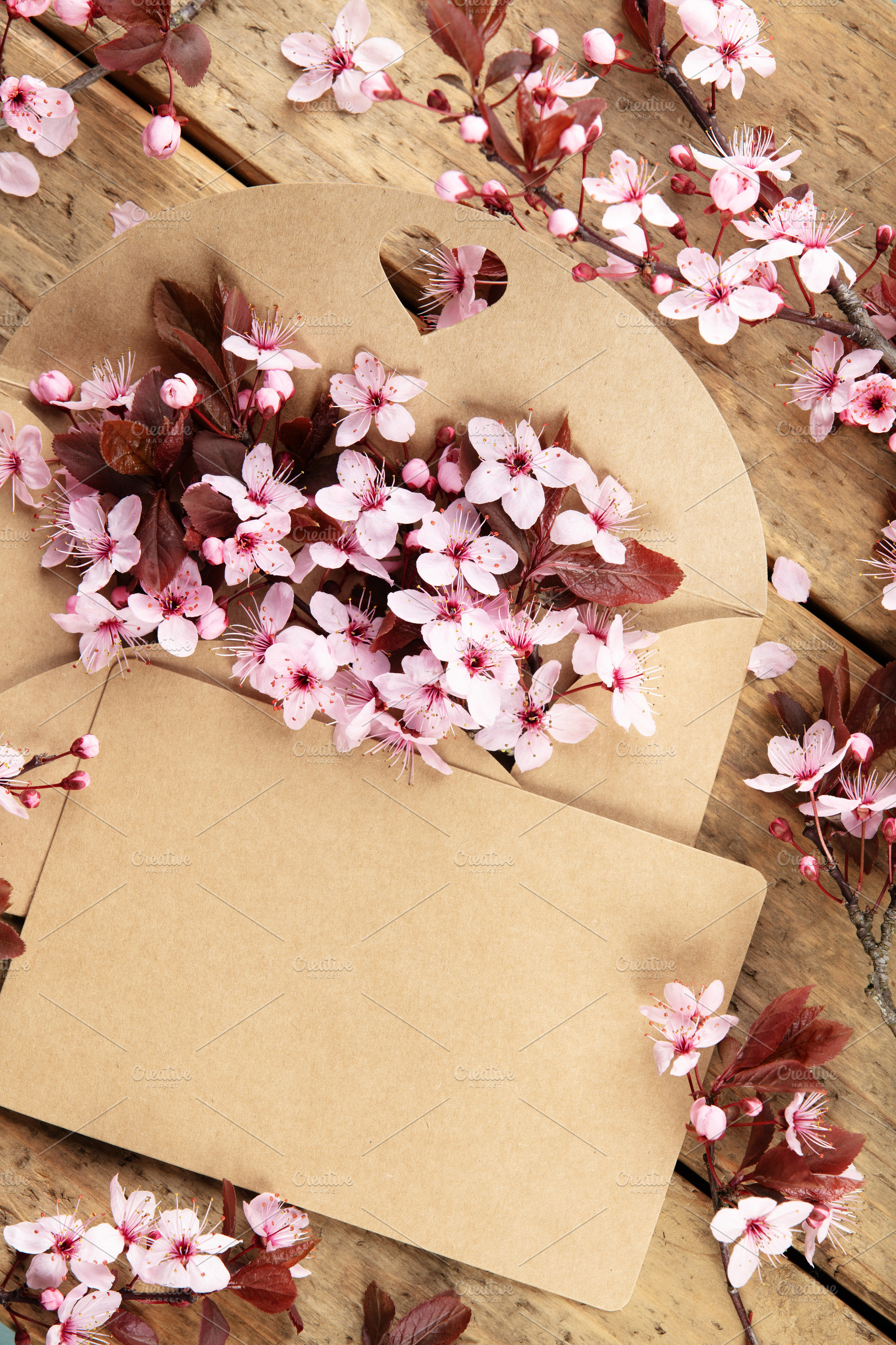 Cherry Blossoms in Kraft Envelope on Rustic Wooden Table, a Holiday Photo by Natalia Klenova's Shop