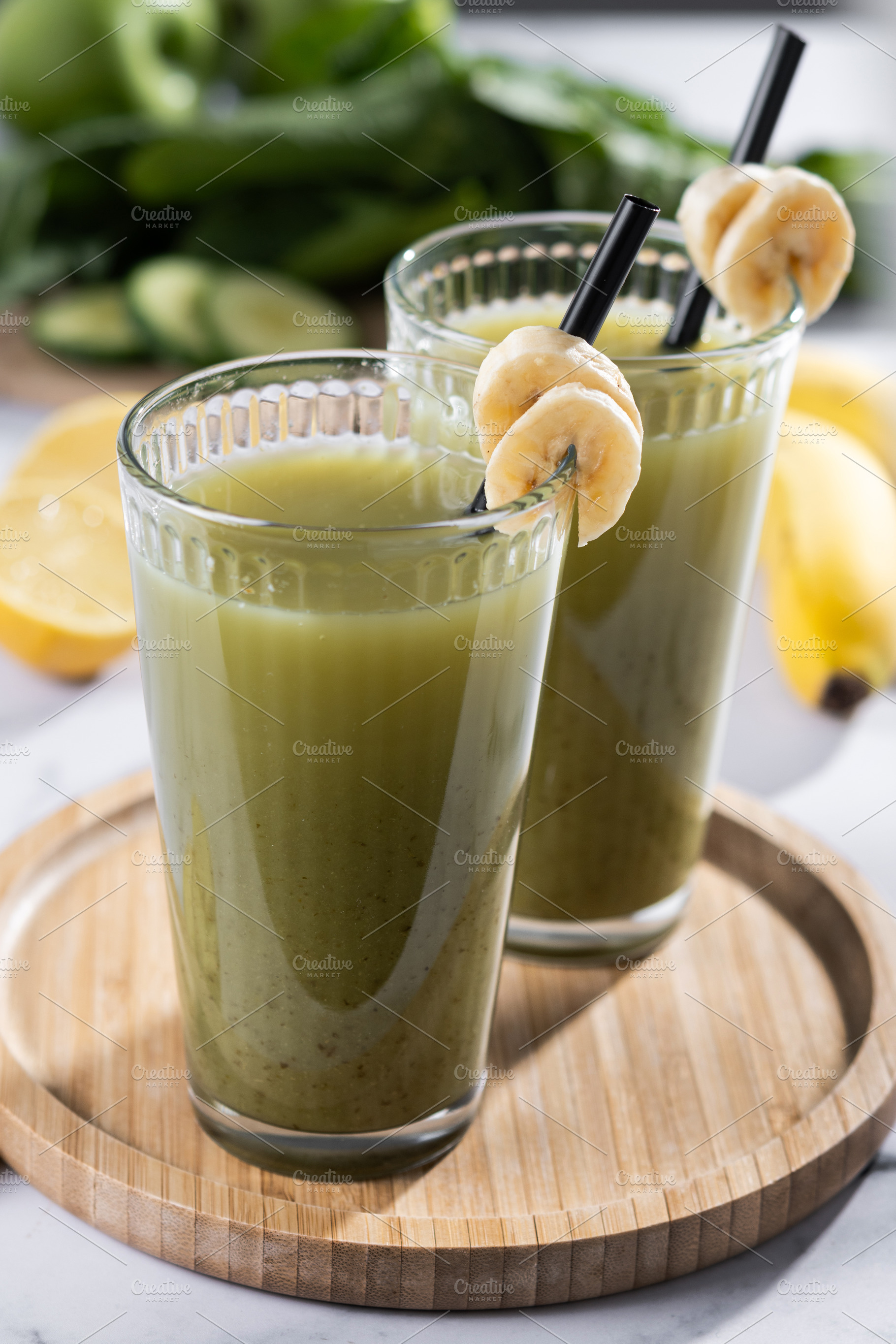 Green smoothie with spinach,banana, apple, and lemon on white ma, a Food & Drink Photo by etorres69
