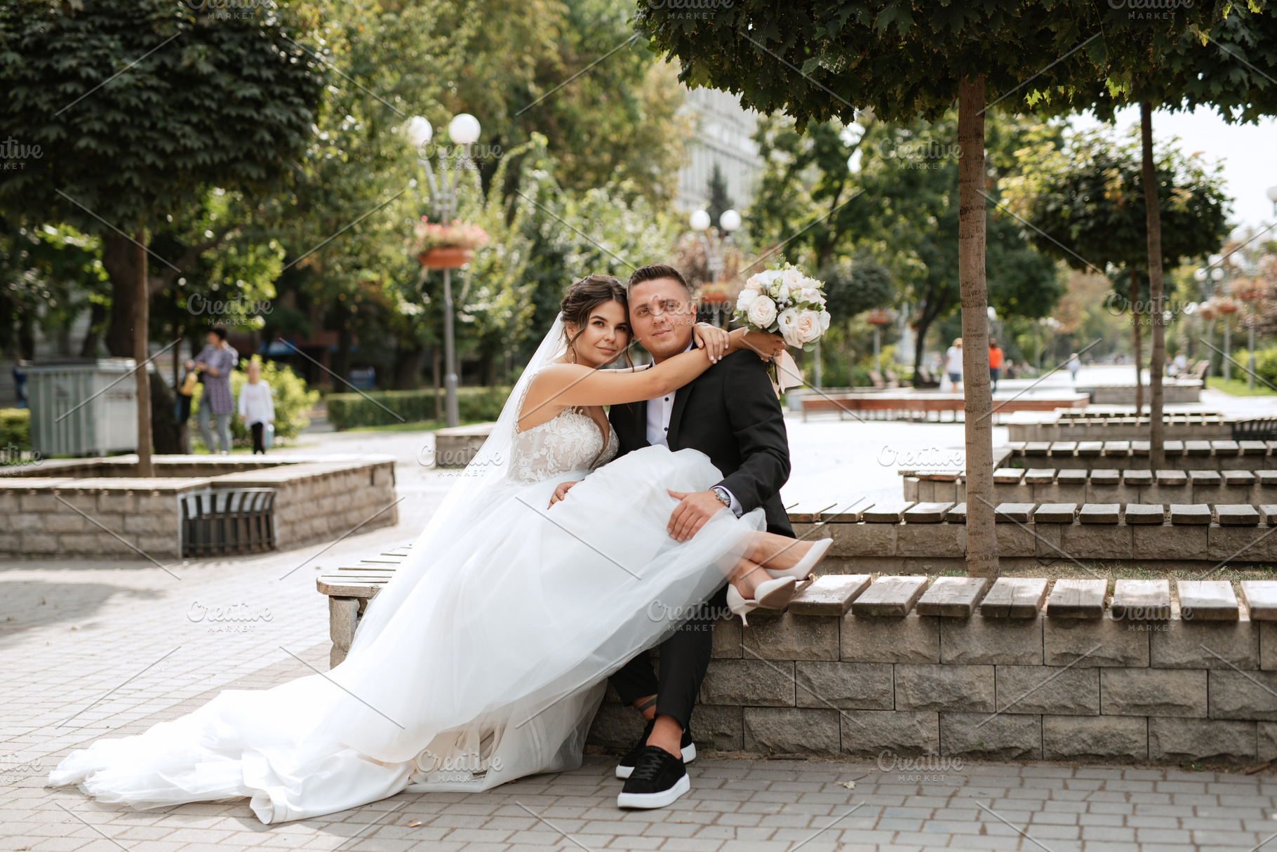 the groom in a brown suit and the bride in a white dress, a Person Photo by Weddings, People, Travel