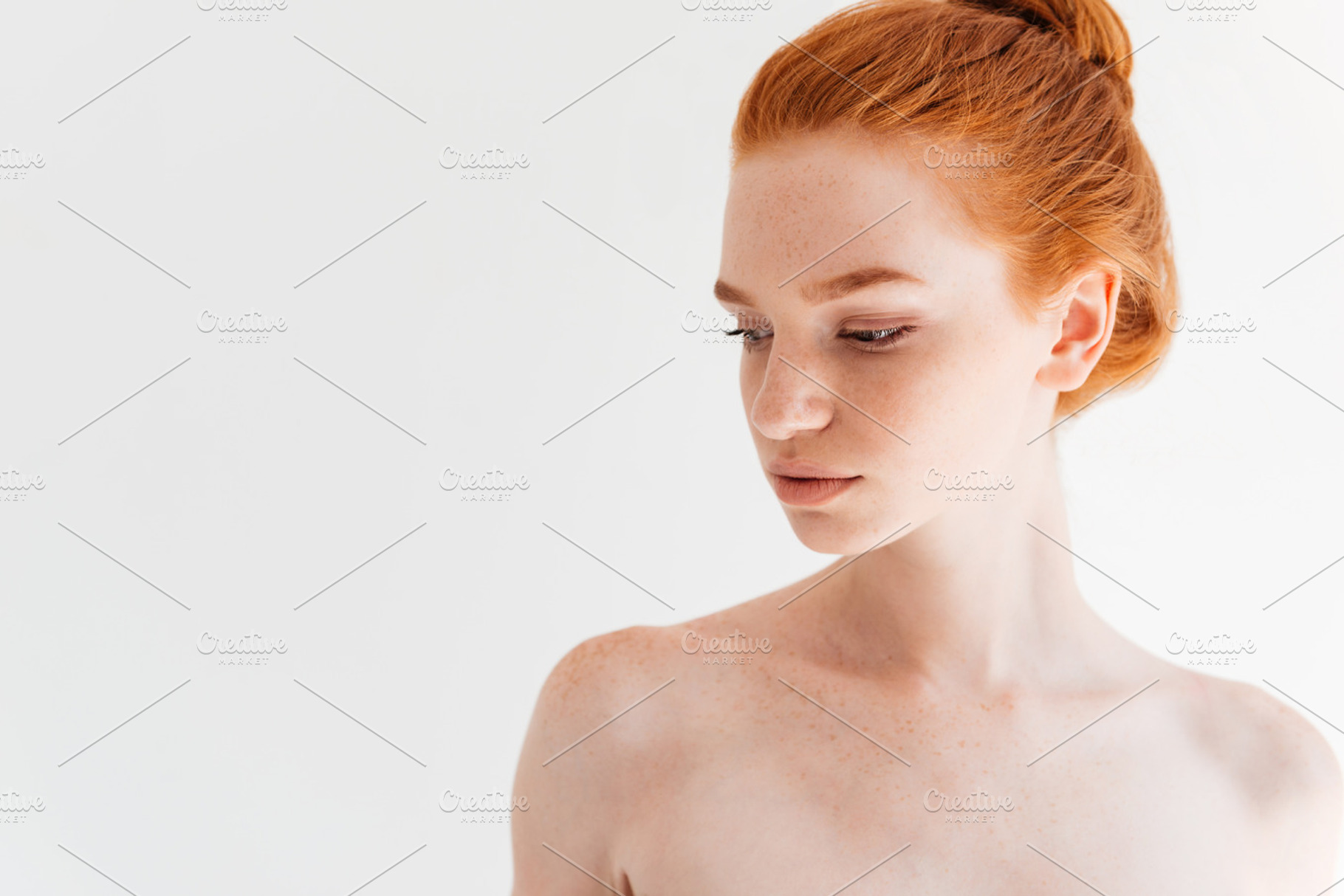 Close up picture of attractive naked ginger woman looking away, a