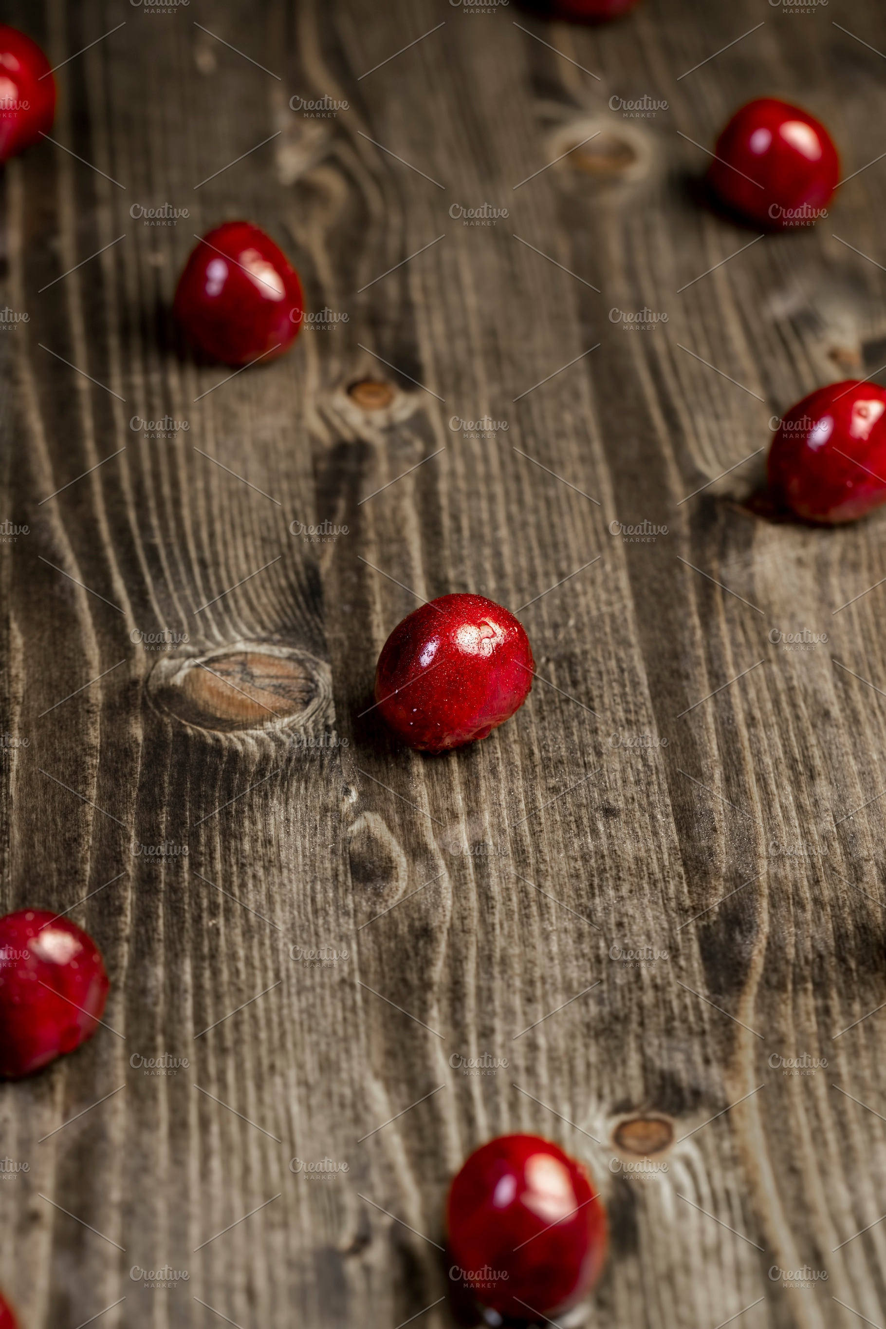 wet red cherry fruits on the kitchen table closeup, The berries are scattered o, a Photo by rsoollAI