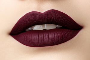 Closeup features full lips adorned with soft burgundy lip gloss, highlighting a, a Photo by AlyaAnd