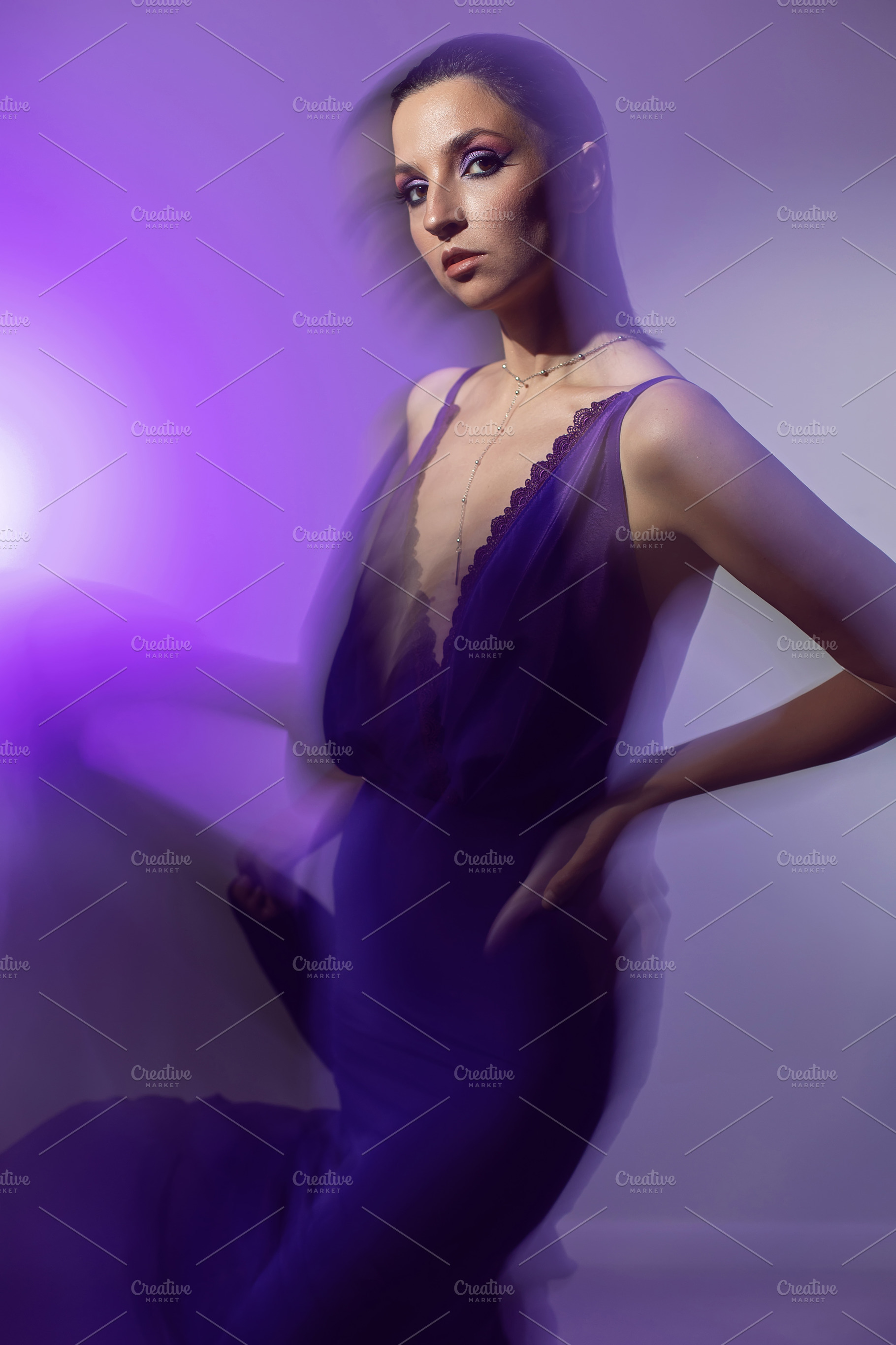 portrait of a brunette woman in a purple dress on white background in the studi, a Person Photo by SaulichPhoto