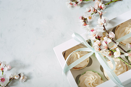 A feminine tea party with vanilla cupcakes and spring flowers