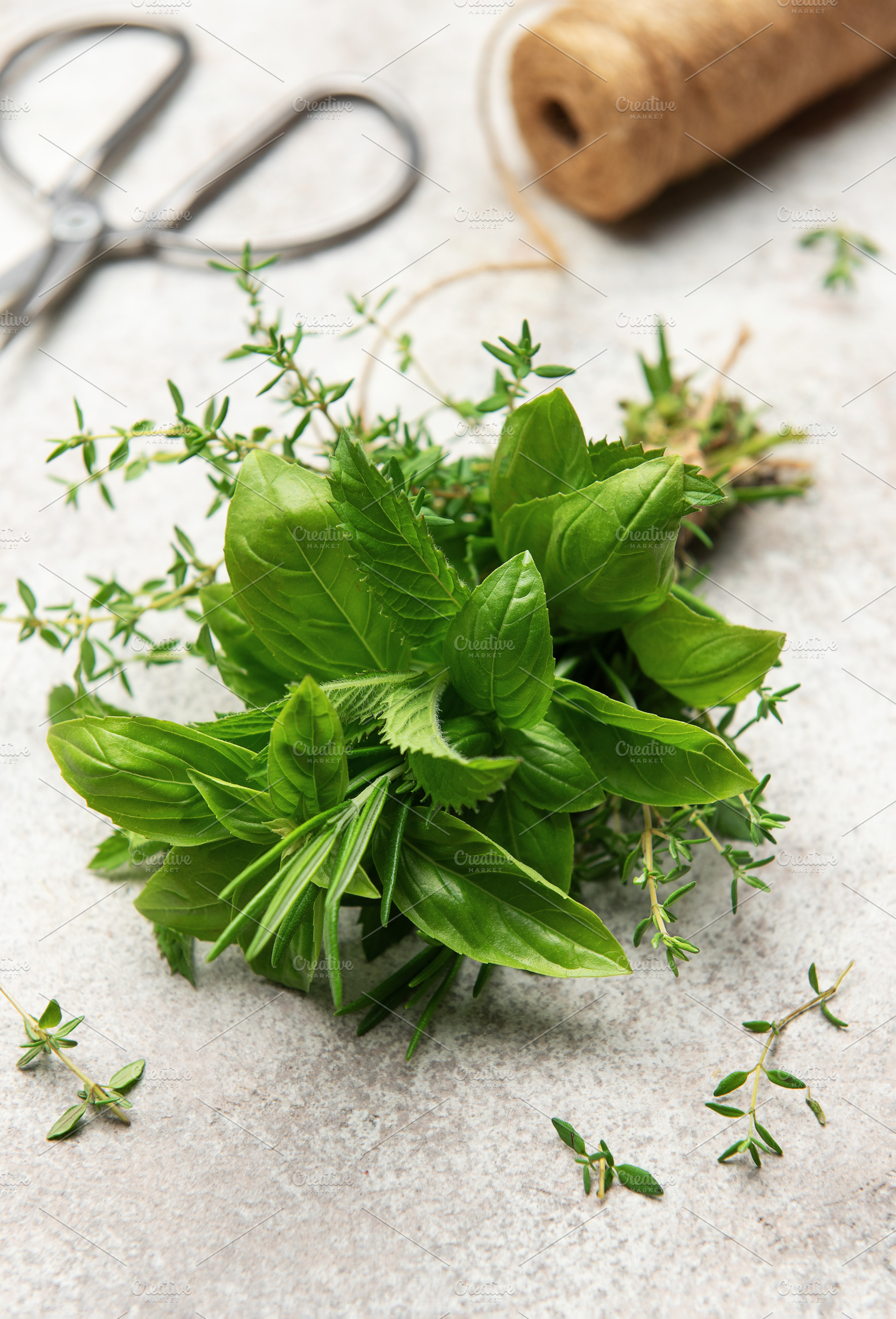 Freshly picked herbs with scissors and twine on kitchen table, a Food & Drink Photo by Olena Rudo