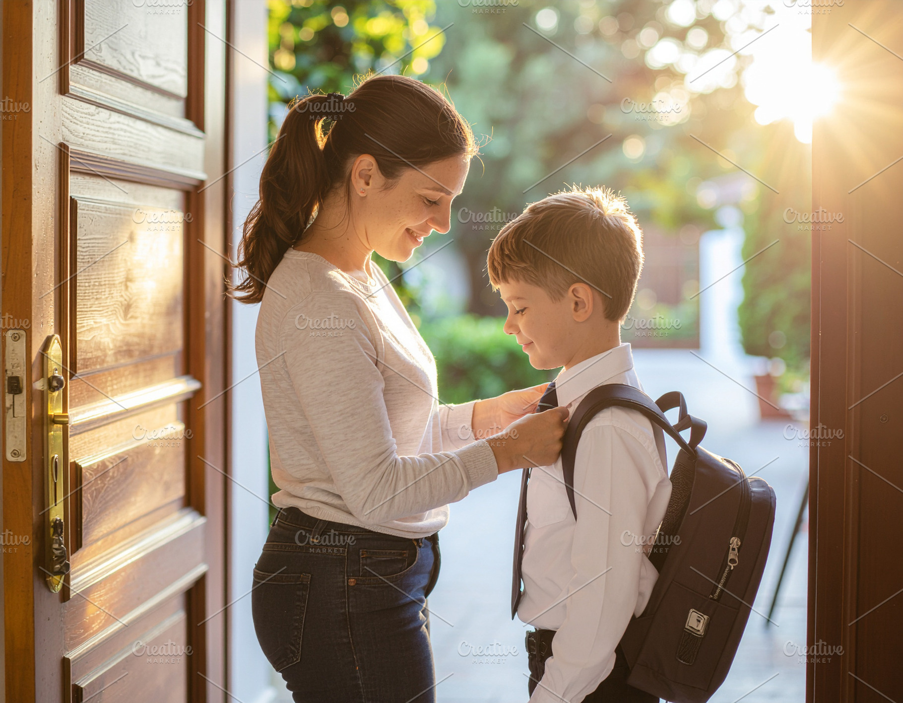 Parent helping child with backpack, a School & Education Photo by DanFLCreativo
