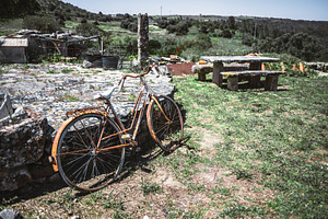 Rusty bike in countryside scene, a Transportation Photo by SkyNext