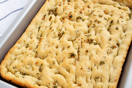 Home-baked Rosemary Garlic Focaccia Bread on baking tray, side v, a Food & Drink Photo by LiudmylaChuhunova