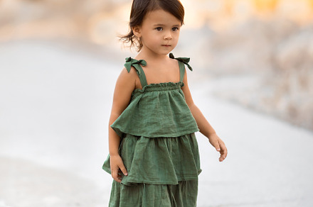 Walking toddler girl in green dress