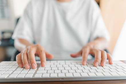 Man working at home, hands pressing computer keyboard, working a, a Business Photo by Art Rachen