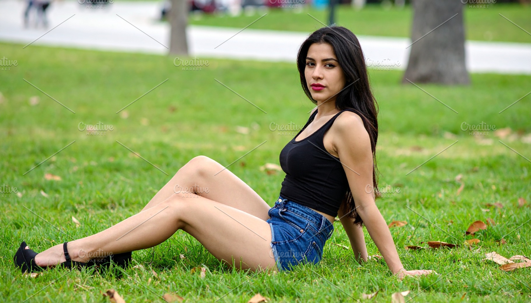 beautiful young woman seated on grass, AI generated, a Photo by WorldOfPhotos