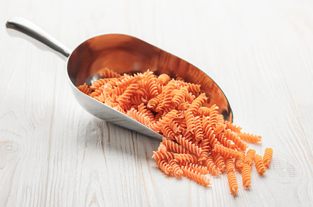 Fusilli red lentil pasta on a wooden background., a Food & Drink Photo by Olena Rudo