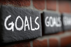 Goals written in chalk on slate tiles against a brick wall conveying ambition,, a Photo by AS photostudio